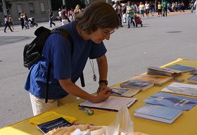 瑞士首都伯尔尼火车站广场上，路人签名声援法轮功反迫害