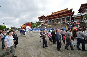 '天国乐团在文武庙广场演奏，一团一团的游客正经过观看，其中有很多来自大陆的游客。'