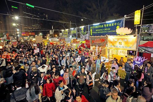 法轮功学员在维园年宵市场开设的真相摊位吸引游人驻目。