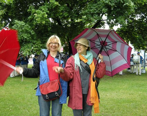 多倫多居民Eva和Marda打著雨傘一直在觀看天國樂團的演奏，她們表示自己是沖這個樂團來的。