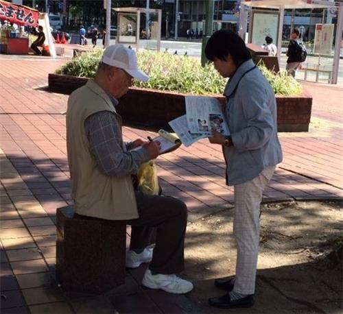 '图1～3：法轮功学员在名古屋市中心向民众讲真相，征签谴责中共迫害。'