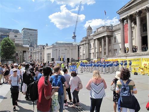 '图4：二零一八年六月三日下午，法轮功学员在伦敦特拉法加广场传播真相，天国乐团的演奏震撼四方，来自世界各地的广大民众踊跃了解真相'