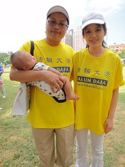 林岳奇（左），手上抱着三个月大的小儿子和妻子一起参加遊行