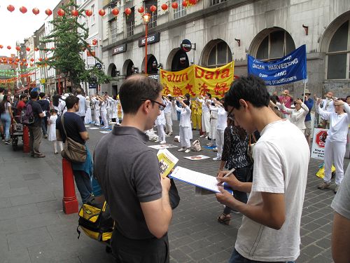 在伦敦唐人街，游人签名支持法轮功反迫害
