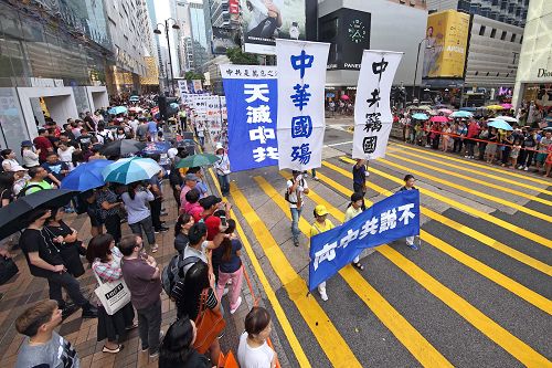 法轮功学员在集会结束后，紧接着进行“法办元凶、停止迫害”的游行活动。