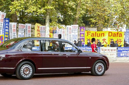 图5：二零一五年十月二十日，在林荫路（The Mall）上，英国女王伊丽莎白二世和爱丁堡公爵的车路过法轮功真相横幅
