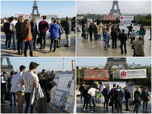 图1：法轮功学员来到巴黎人权广场，举行了集会活动，图为人们围着法轮功的信息台了解真相
