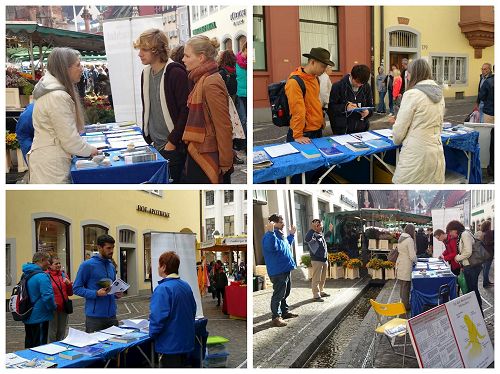 '图：二零一七年十月七日，德国法轮功学员在著名旅游城市弗莱堡举办信息日，设立真相点，吸引各方民众驻足了解法轮功。'