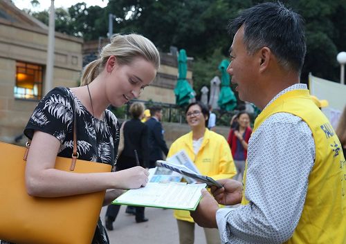 '图5：从事气象变化研究的Burns女士了解真相后她在支持制止迫害征签表上签名。'