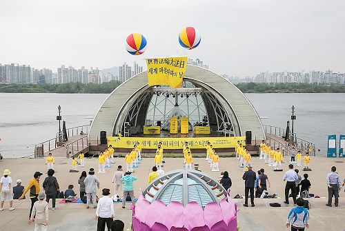'图1：5月13日，韩国部份法轮功学员和市民们汇聚在汝矣岛汉江公园，欢庆第18届“世界法轮大法日”及法轮大法洪传25周年。'