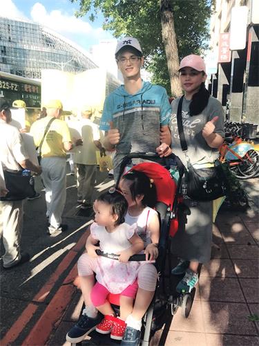 '图10：李娸嘉夫妻和小孩全家参加七二零反迫害游行活动'