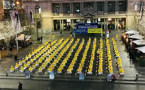 '图1～2：悉尼法轮功学员在海关大楼前烛光悼念二十年中被中共迫害致死的法轮功学员'