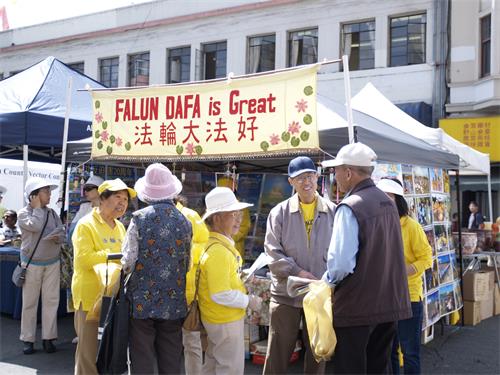 图1:二零一九年八月二十四日,法轮功学员在北加州奥克兰中国城中秋街会上摆放摊位,传播真相。前来了解真相的人们络绎不绝。