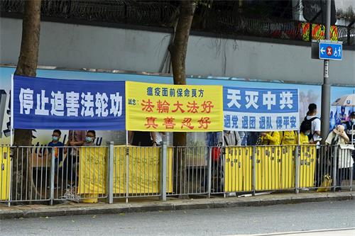 '图1：二零二一年四月二十五日，香港法轮功学员在中联办前挂横幅抗议中共的迫害。'