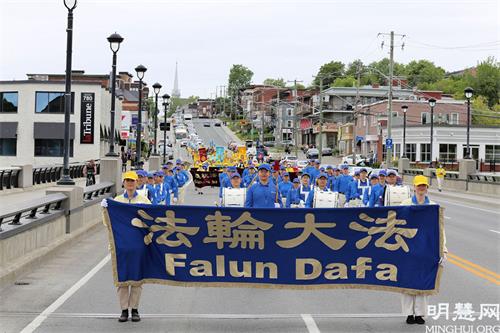 '图1:2021年5月30日,法轮功学员在加拿大魁北克省舍布鲁克市(Sherbrooke)举行游行活动,庆祝世界法轮大法日暨法轮大法(法轮功)弘传世界29周年。'