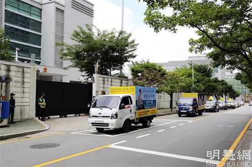 '图2：釜山法轮功学员的游行车队行经中国总领事馆。'
