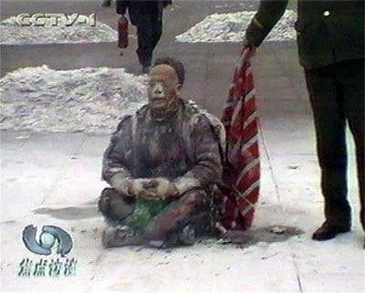 图4：王进东这位演员，号称双腿夹着的雪碧瓶，是用来装点燃自己的汽油的视频截图。（纪录片《伪火》中的视频截图）