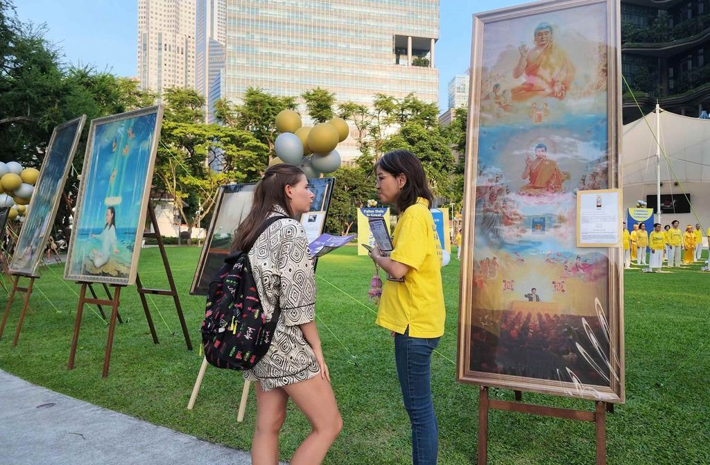 '图5~11:二零二六年七月二十一日,新加坡部分法轮功学员在芳林公园举办纪念李洪志师父莅临新加坡讲法暨法轮佛学会成立30周年庆典。图为各国各族裔民众纷纷驻足,了解法轮功真相。(明慧网)'