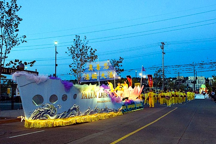 图12~13:二零零五年七月三十日晚,法轮大法法船首秀西雅图市中心的海洋节火炬大游行。吸引现场25万游客和电视7台KIRO-7独家实况直播的70万人观赏。 (明慧网)
